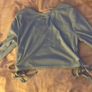 Size M long sleeve light blue shirt with ties on the sides